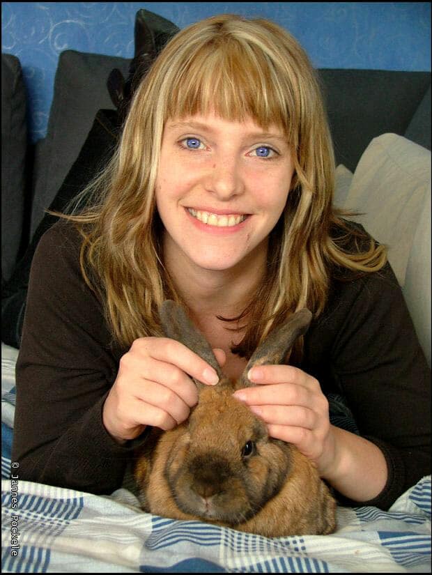 girl petting her rabbits ears